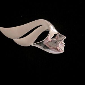 Vintage silver tone, art, deco, brooch, depicting a woman’s face ,flowing hair